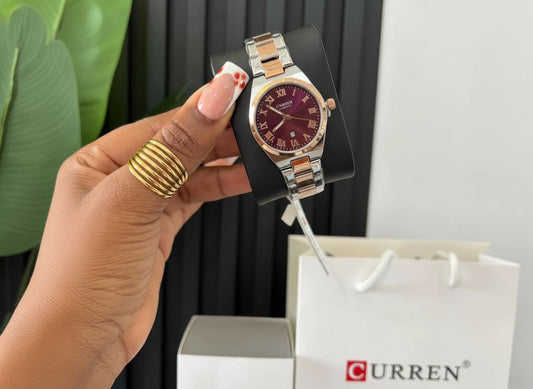 Montre de luxe Curren pour femme avec bracelet bicolore argent et or rose, cadran bordeaux et détails dorés présentée par AuraRichStore Abidjan.